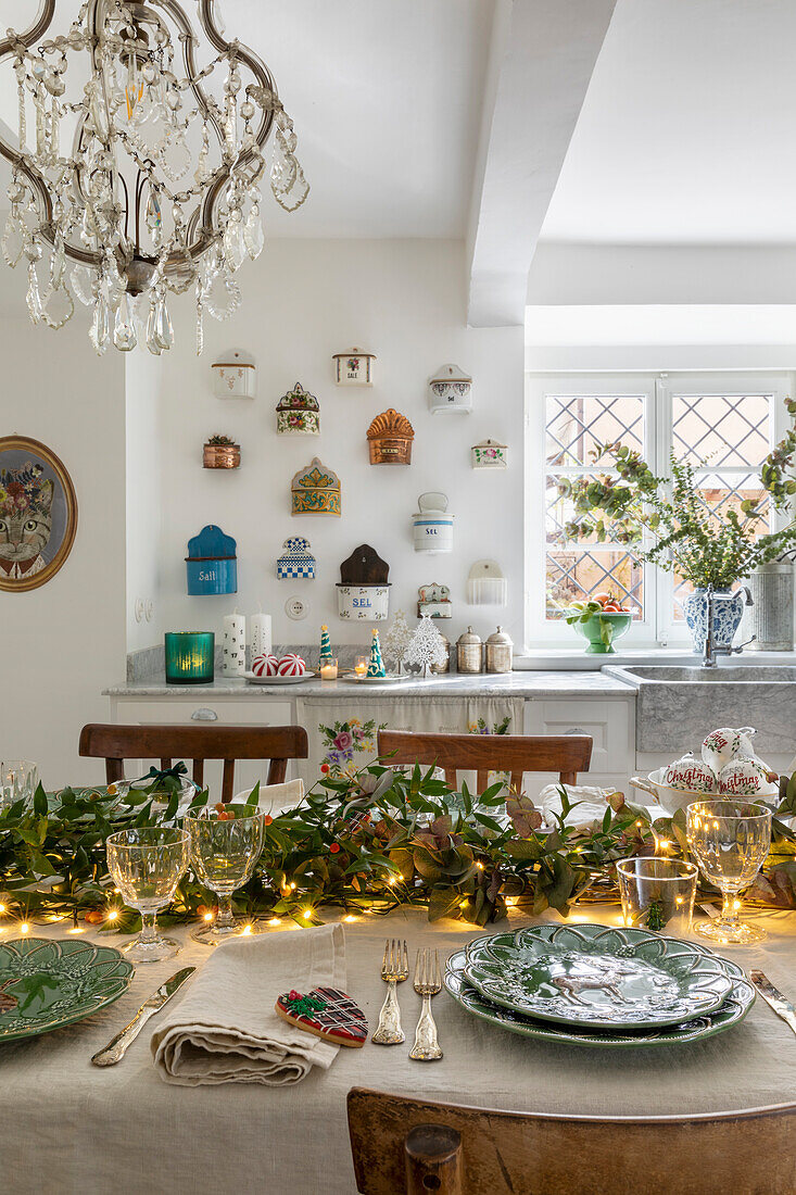 Festive table setting with fairy lights and ceramic wall decorations