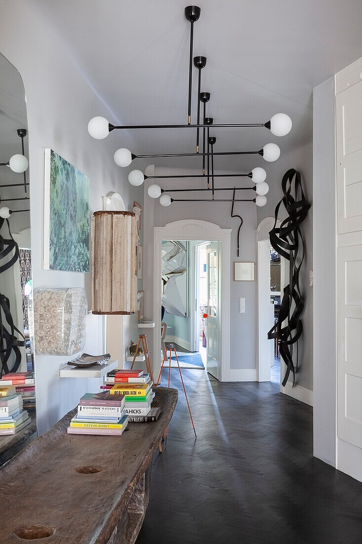 Hallway with modern lamp and rustic console