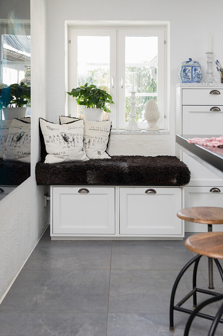 Cozy bench with storage space under a window in the kitchen
