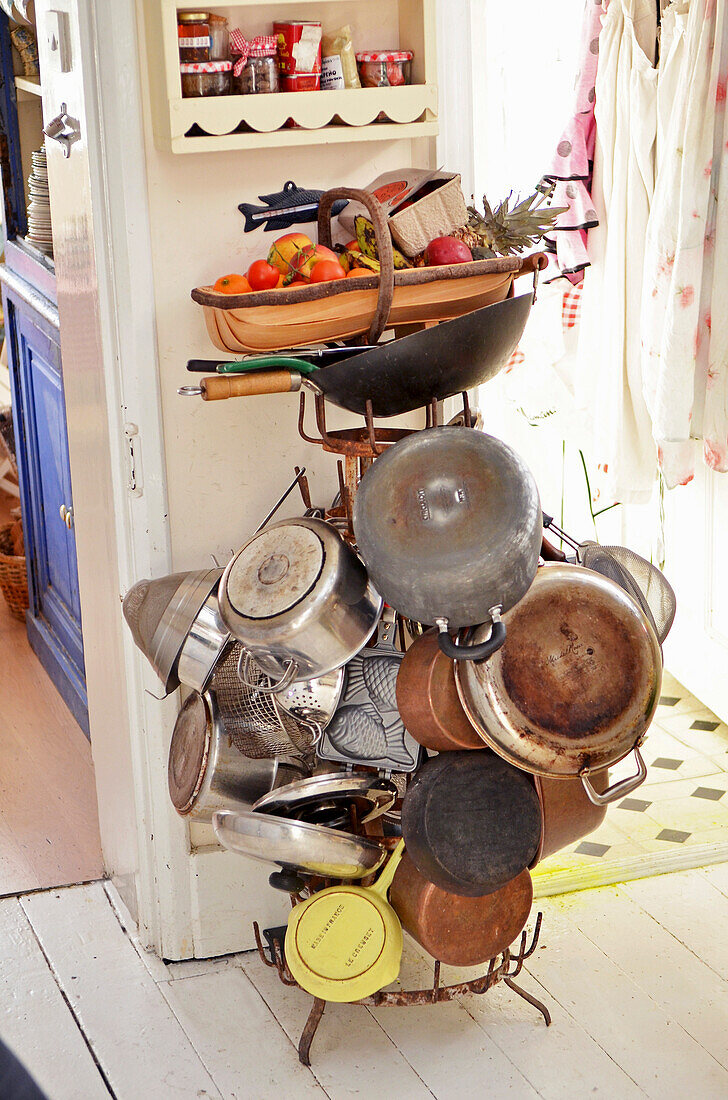 Pots and pans on an old drying rack in kitchen