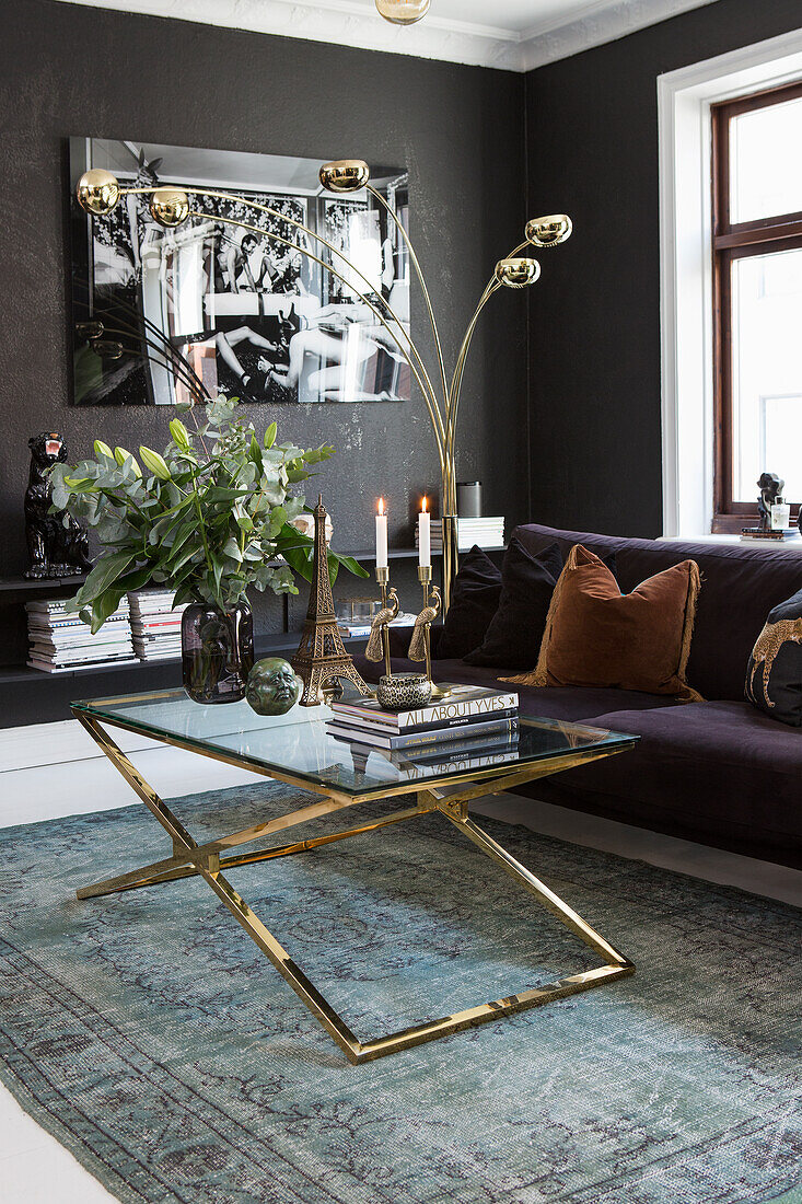 Living room with dark walls and gold-colored coffee table