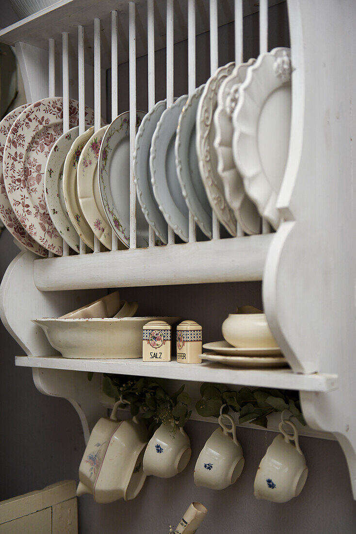 Plate rack with old porcelain dinnerware