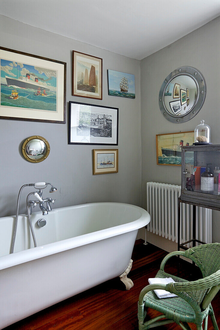 Freestanding bathtub in a traditional bathroom with a picture gallery