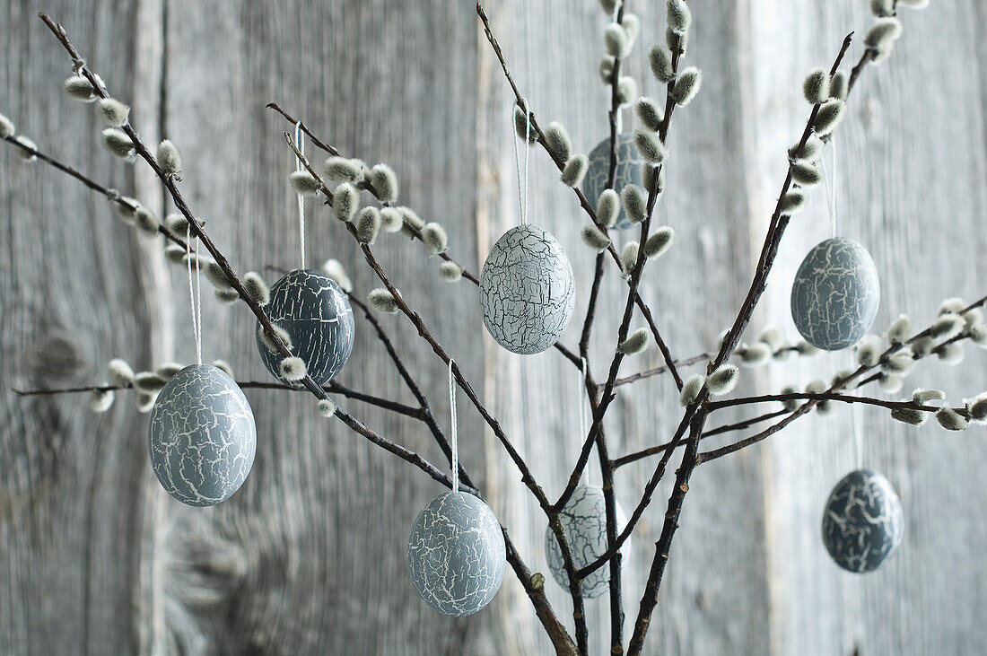 Hand-painted Easter eggs hanging from willow twigs