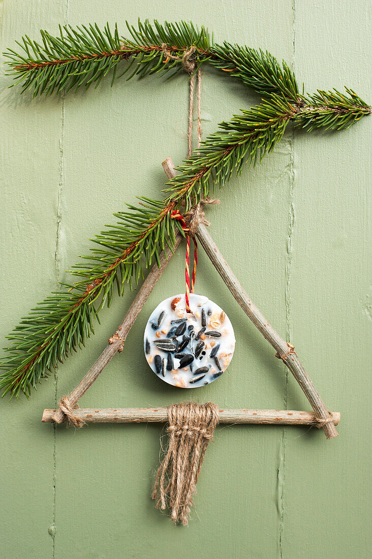 DIY winter decoration made from twigs and seeds enclosed in coconut oil