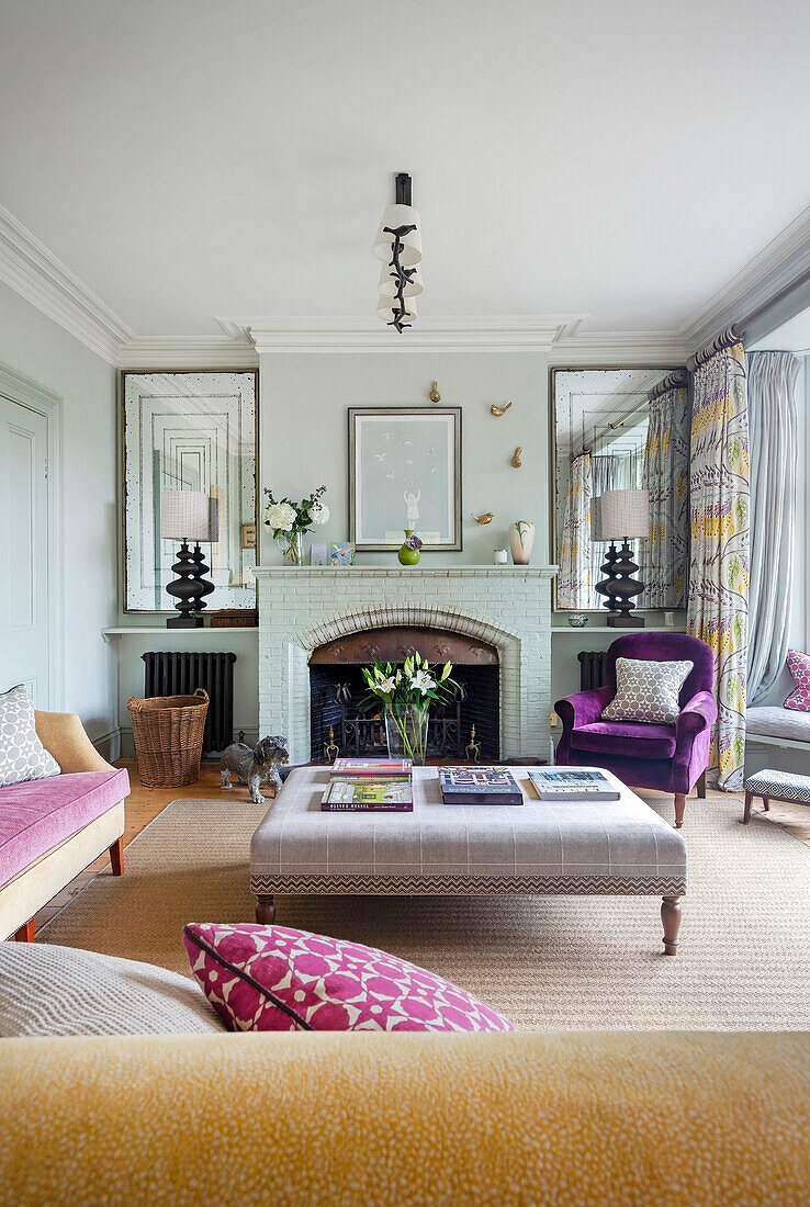 Living room with fireplace, seating and pastel green walls