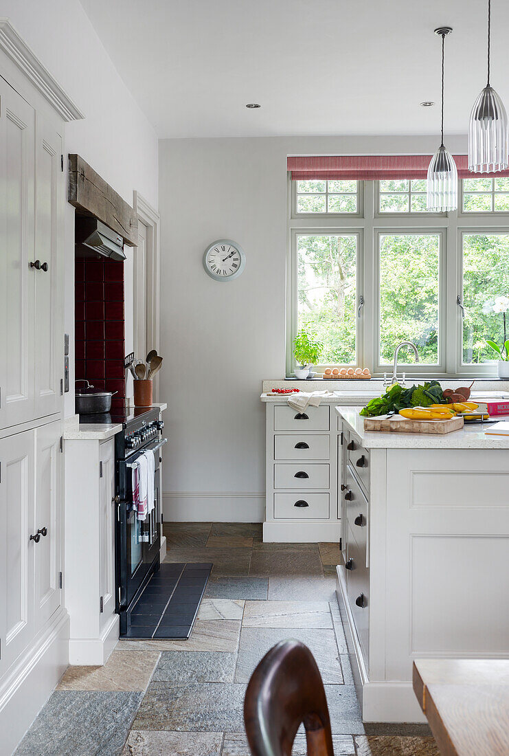 Bright country kitchen with natural stone tiles and kitchen island