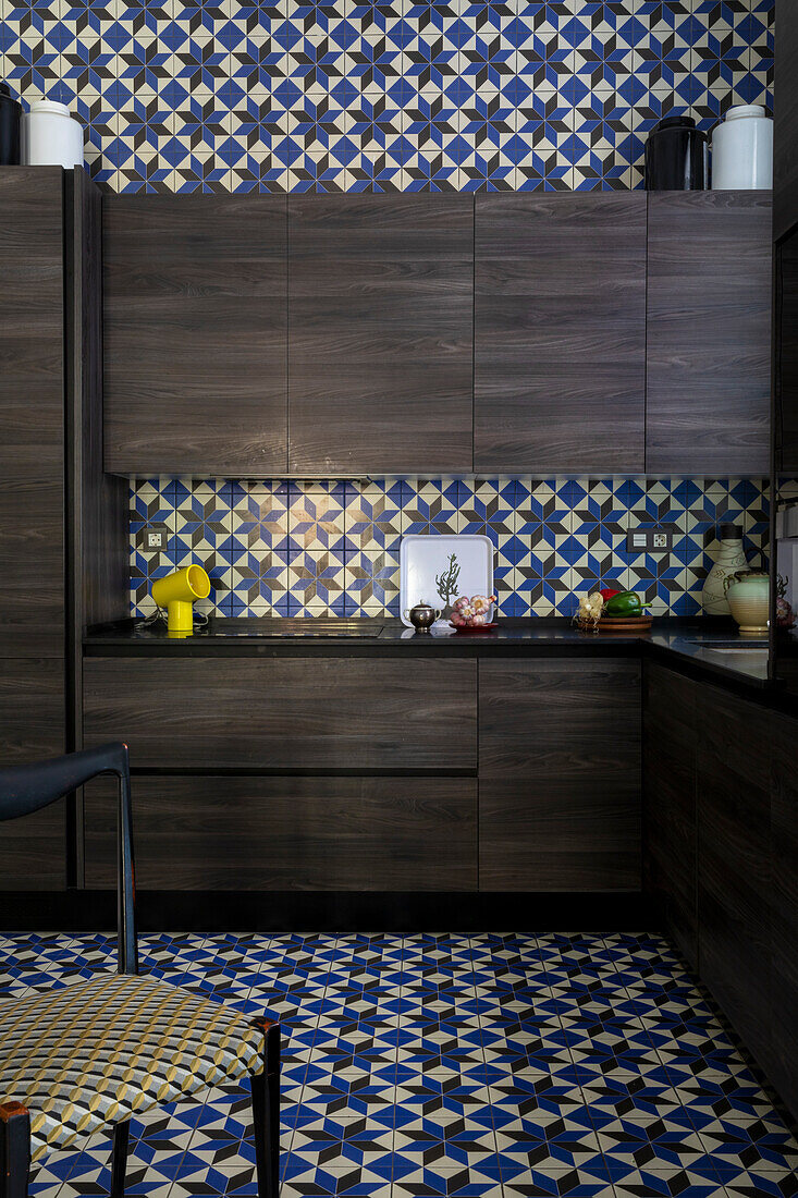 Dark stained oak cabinets in the kitchen with decorative tiles