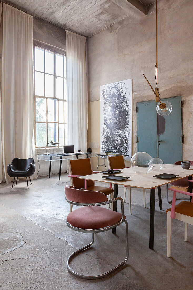 Loft study with concrete walls, modern art and retro furniture