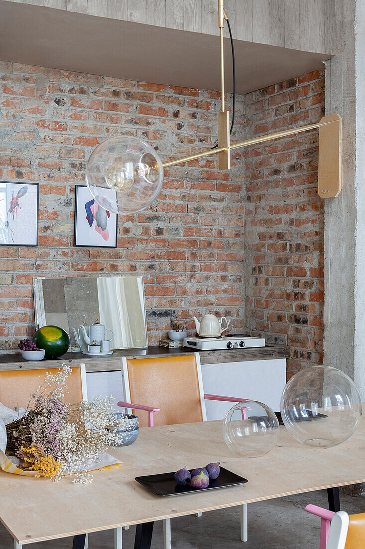 Wooden table, brick wall and modern lamp