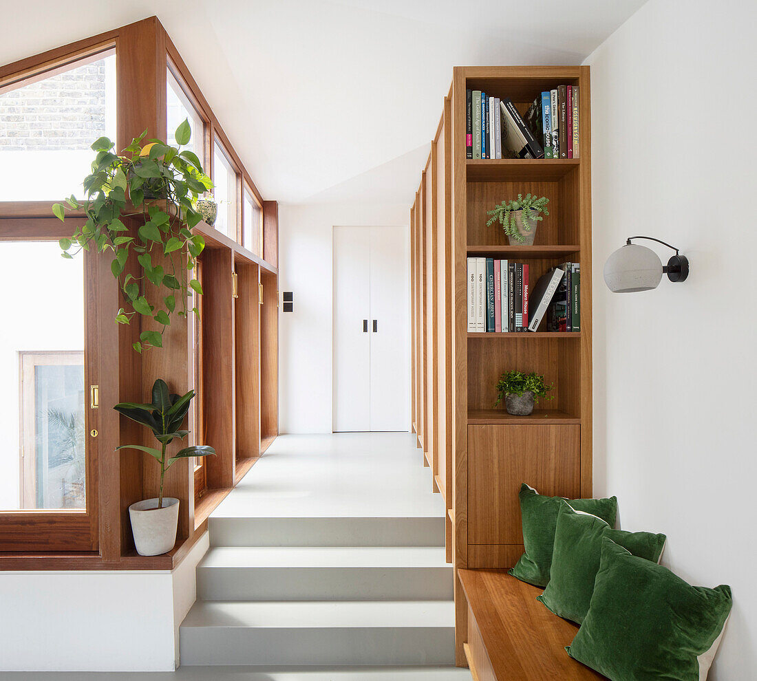Hallway with custom-made shelves and cupboards and low sideboard used as a bench