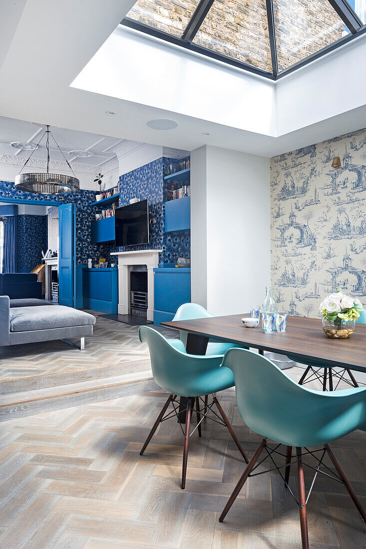 Open-plan living room with kitchen and dining area, skylight