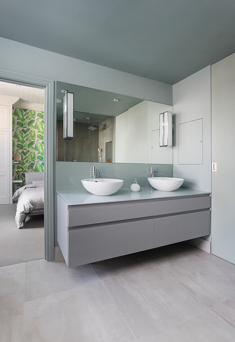 Modern bathroom with double washbasin and mirror