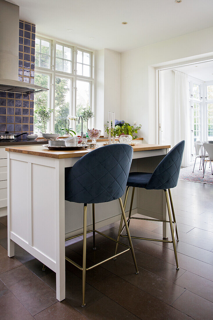 Elegant bar stools with velvet upholstery at kitchen island