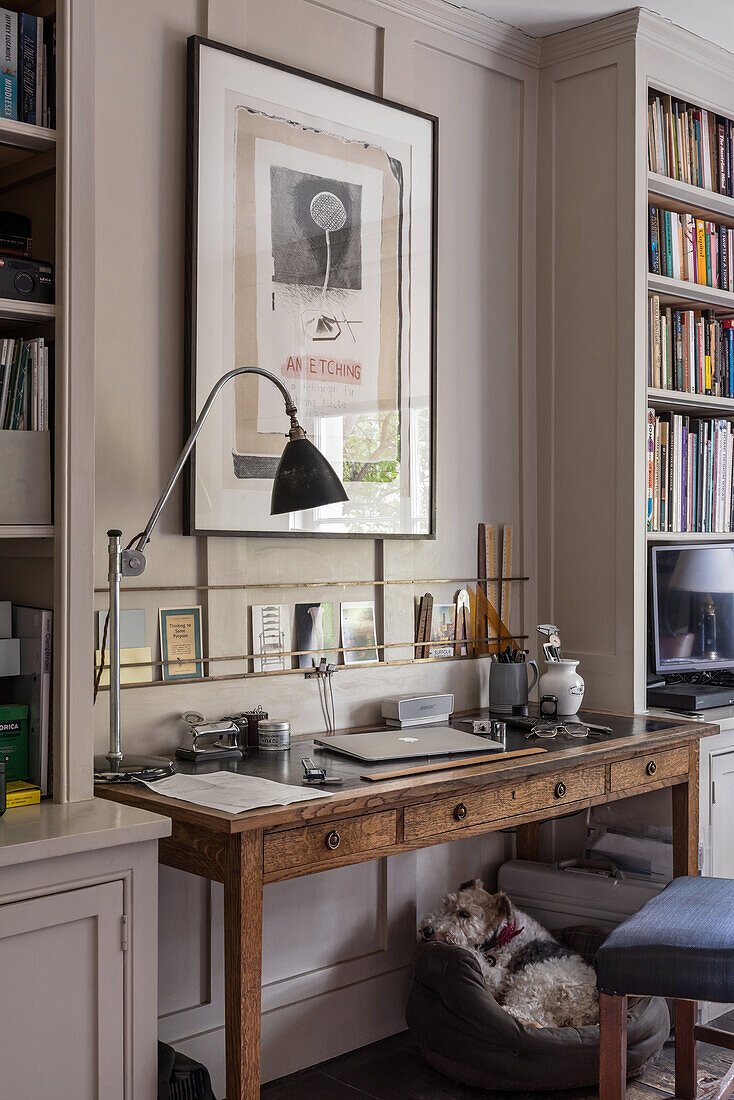 Brass rails above writing desk with postcards and poster