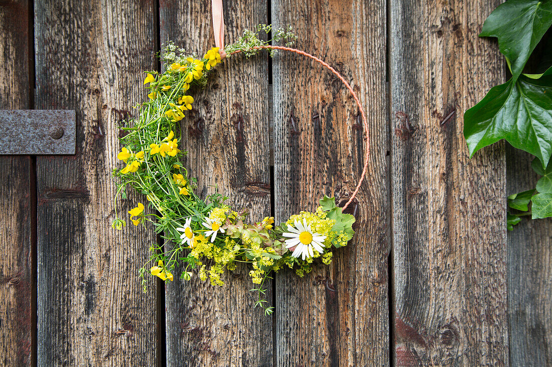 Floral wreath on rustic wooden wall