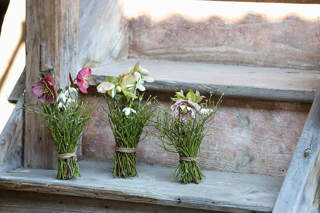 Posies of early flowers (black hellebore, Lenten rose, bilberry twigs and snowdrops)