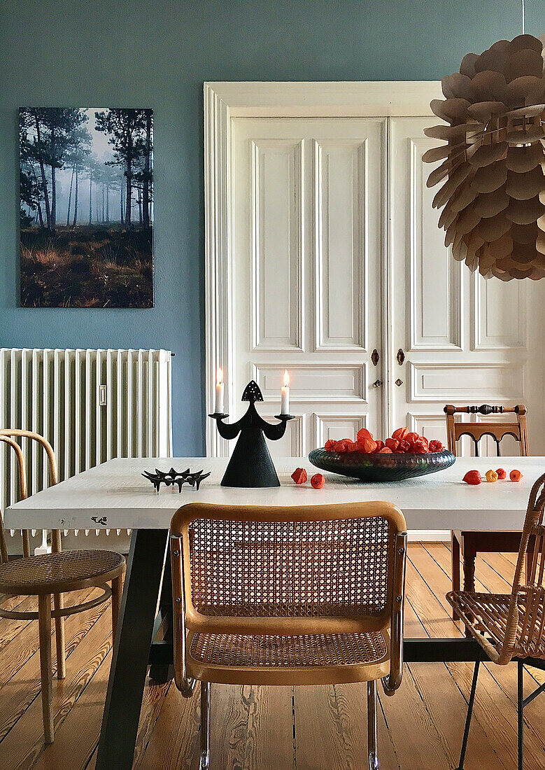 Autumnal arrangement on table with white top in dining room