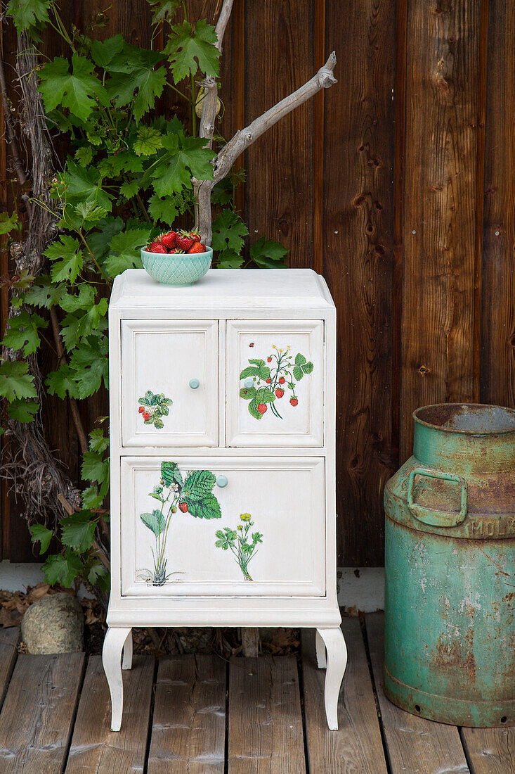 Refurbished bedside table with strawberry motif on the terrace