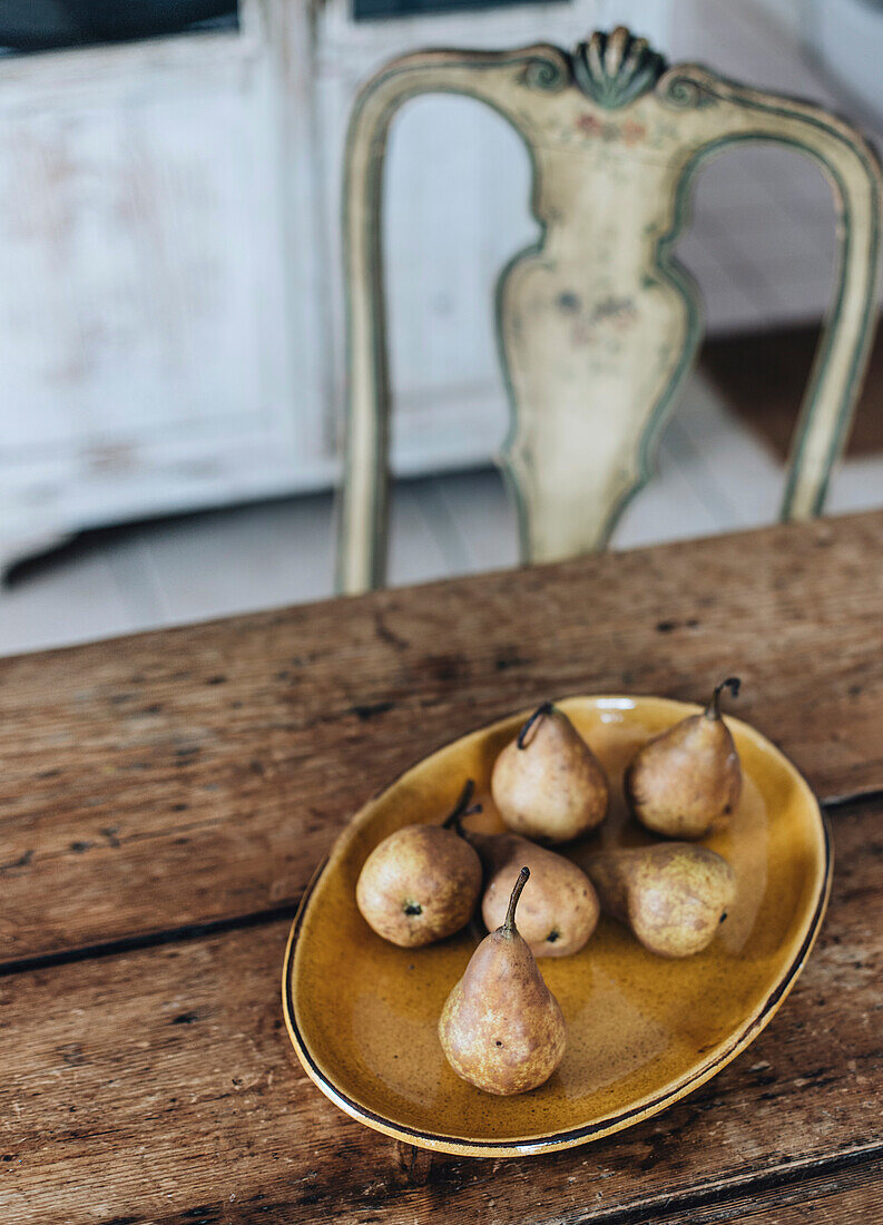 Ceramic plate with pears on rustic wooden table