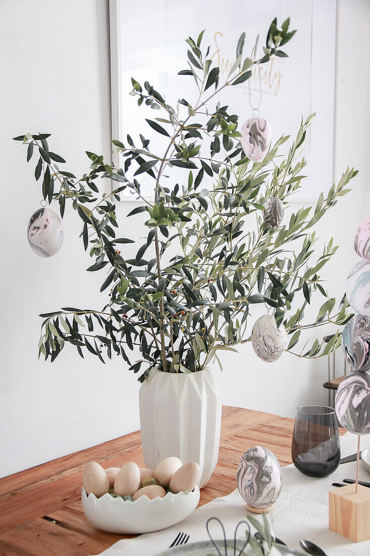 Easter bouquet made from olive branches with painted eggs