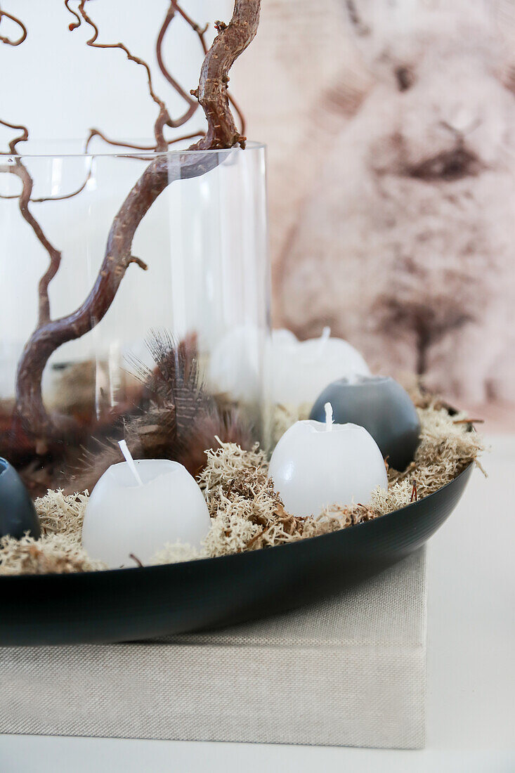 Decorative bowl with white and black candles on moss, bunny picture