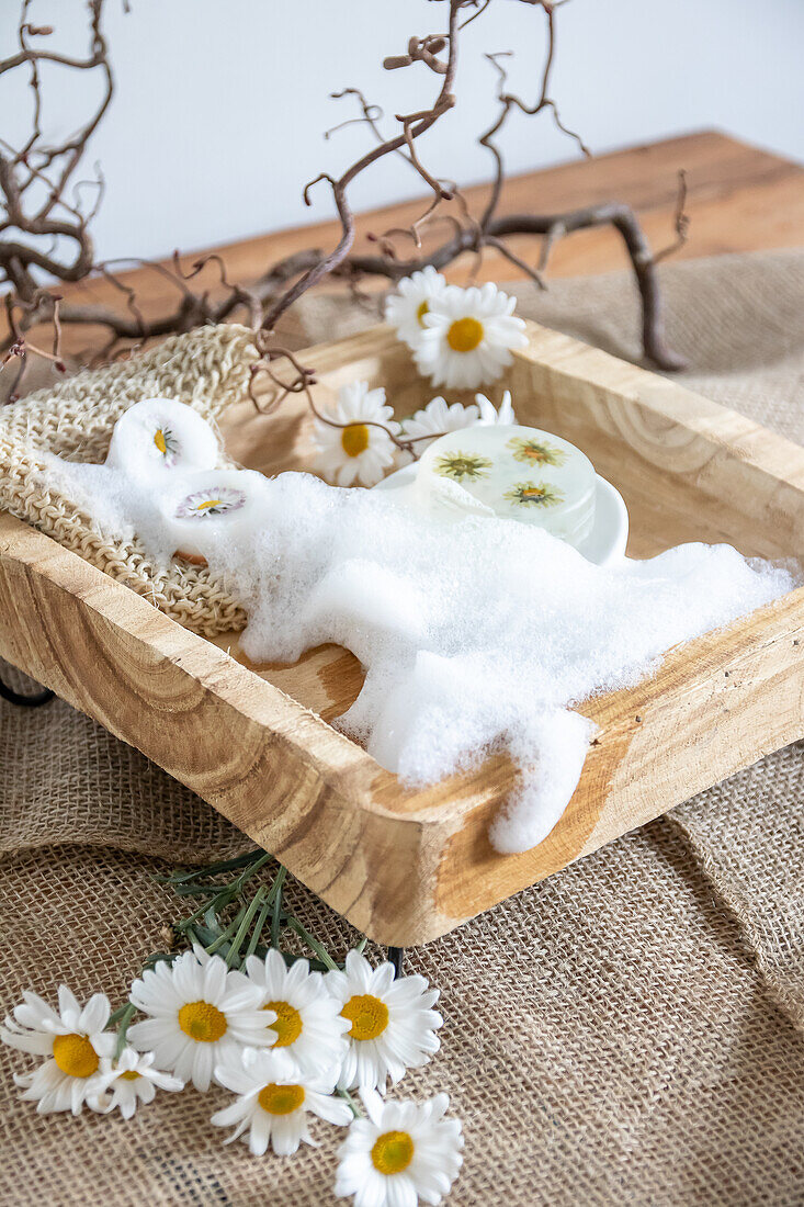 Wooden tray with foam, soap and flowers