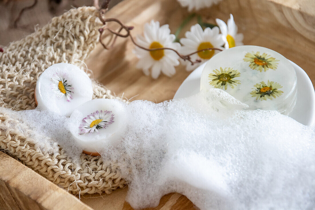 Soap bars with flowers on a wooden tray