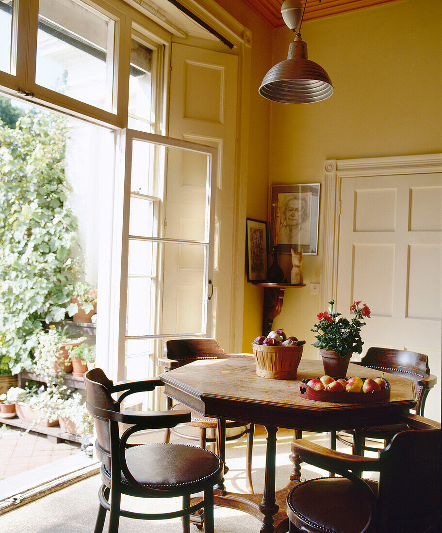 Dining room with view through open French window to patio