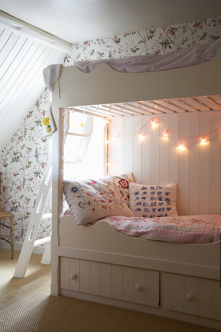 Bunk beds in floral patterned attic space in Rye, Sussex