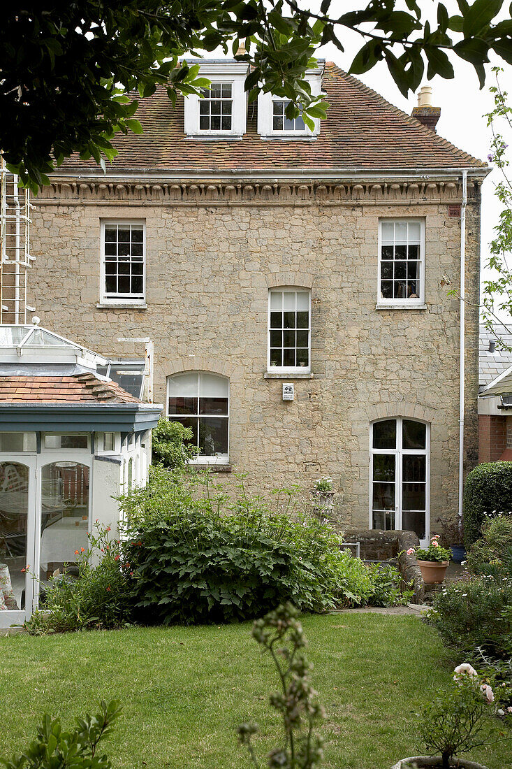 Stone exterior and back garden with conservatory in Arundel, West Sussex