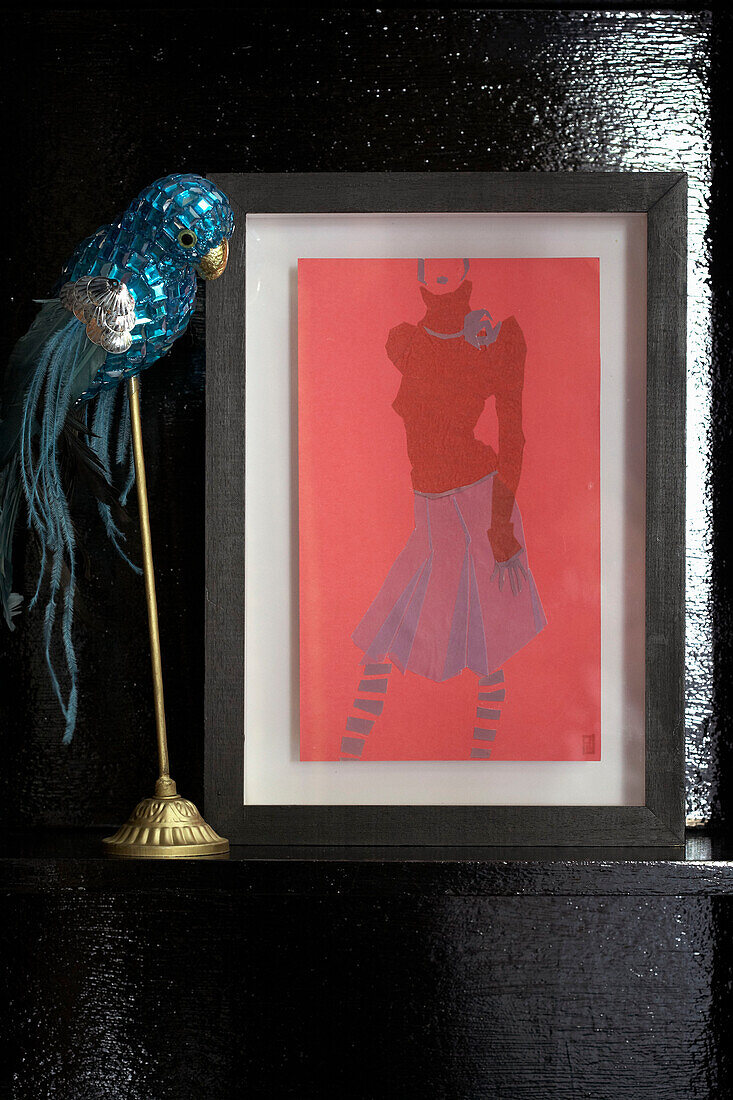Sequined parrot and fashion artwork on black wall