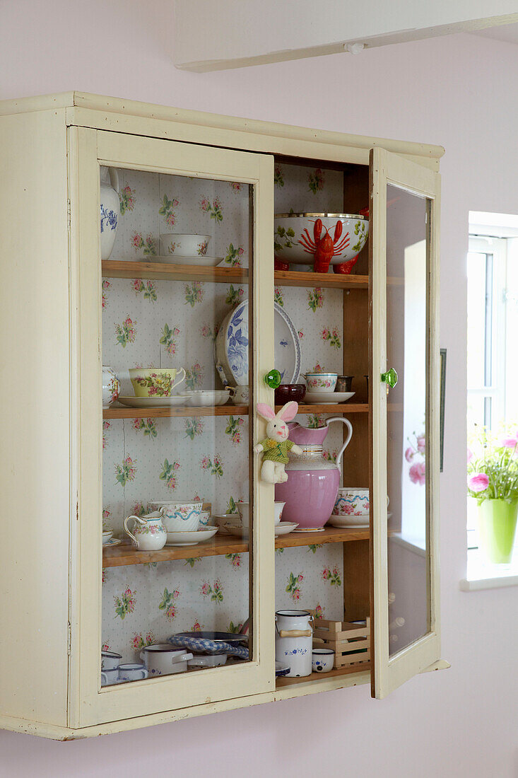 Wallpapered kitchen cabinet with chinaware