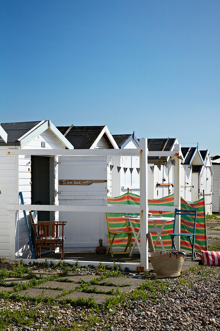 Line of beach huts on West Sussex coastline, England, UK