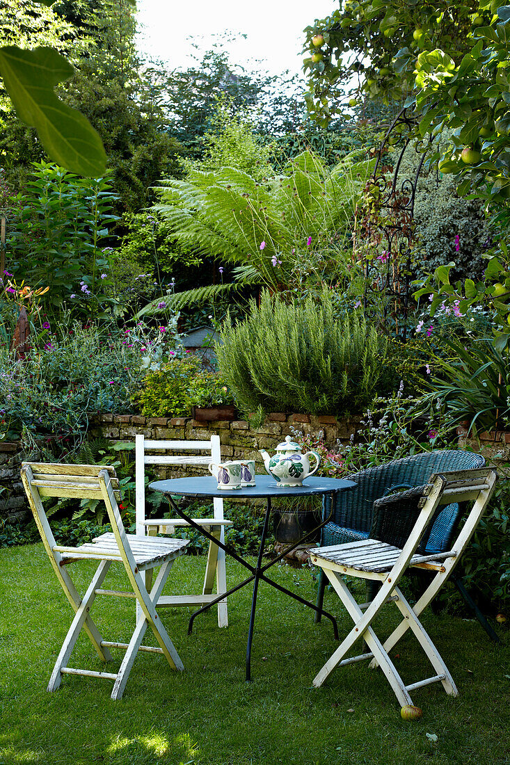 Folding table ad chairs in back garden of Brighton townhouse, Sussex, England, UK
