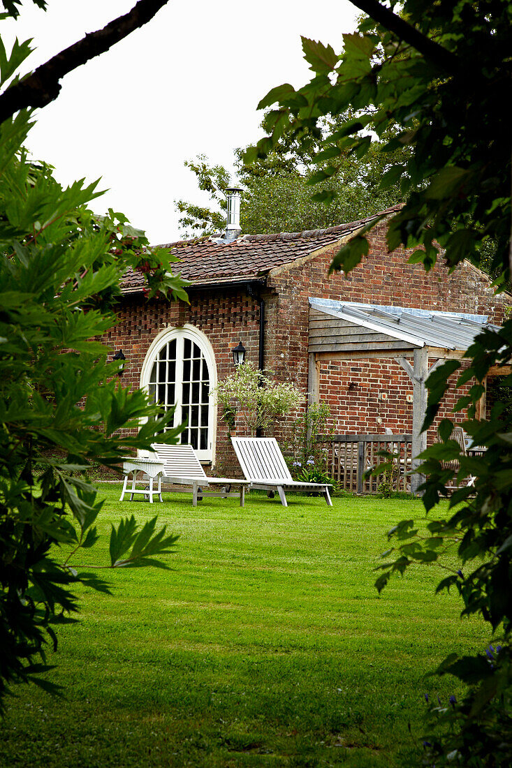 Sun loungers on lawn of West Sussex home, England, UK