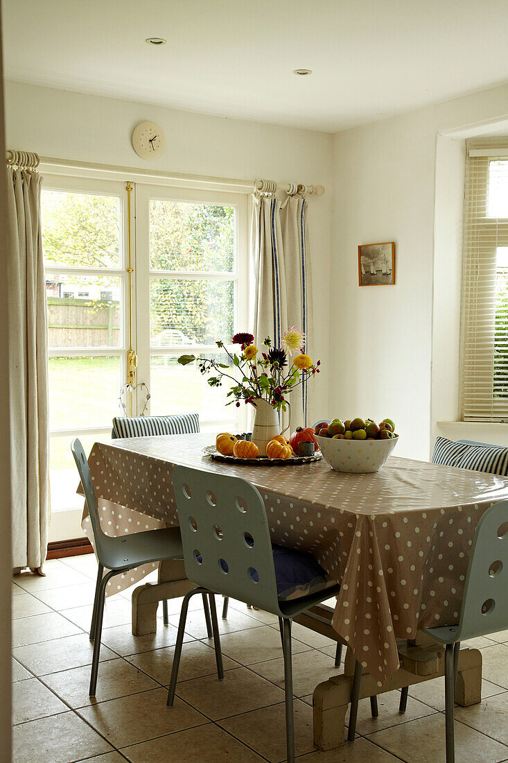 Dining table with double patio doors in Norfolk beach house, UK