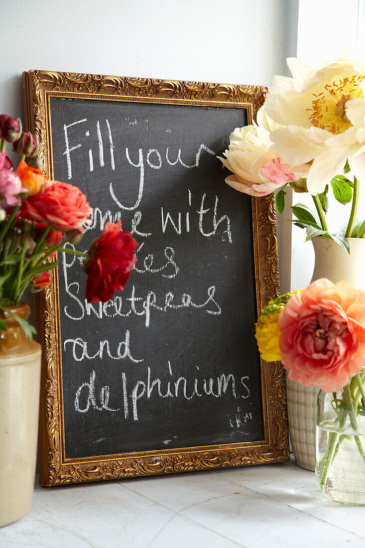 Handwriting on blackboard with cut flowers in Lincolnshire home, England, UK