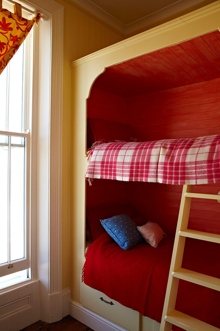 Red painted bunk bed in Cromer beach house, Norfolk, England, UK