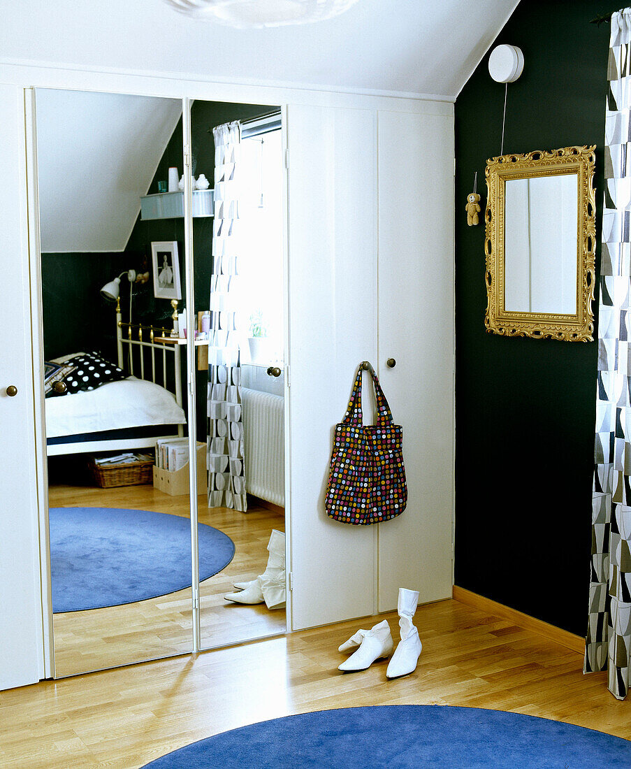 Double bed reflected in built in mirror wardrobe