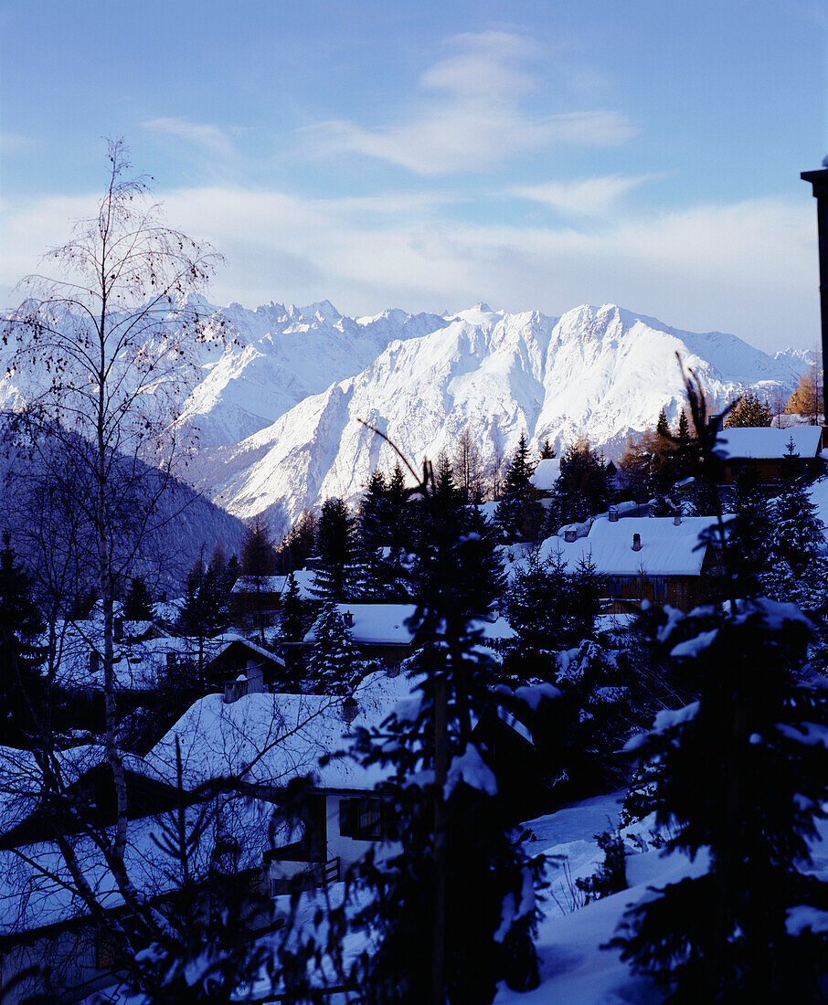 A view of the ski resort of Verbier chalets snow covered mountains in the distance