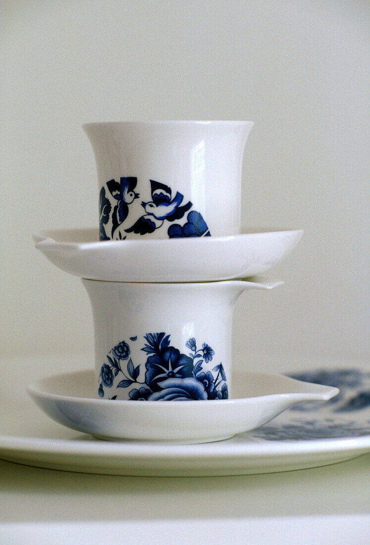A detail of two cups and saucers decorated with a blue motif