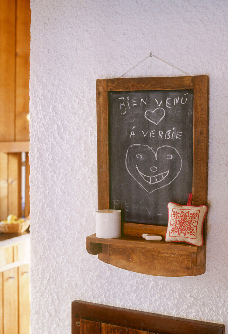A detail of a rustic country kitchen wooden chalkboard