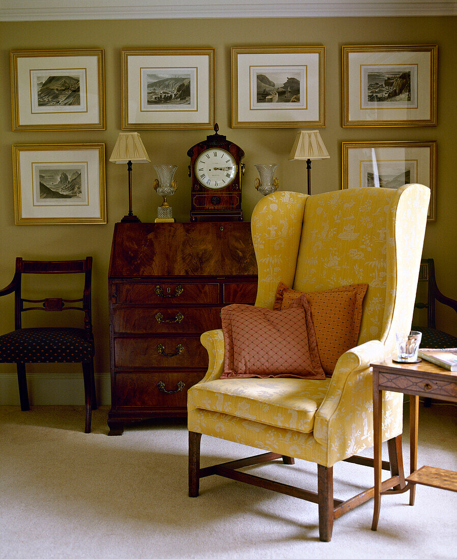 Upholstered wing back chair next to wooden table