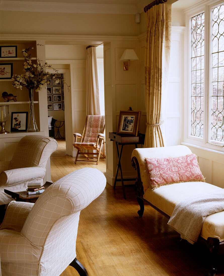Two armchairs and a long reclining armchair in a traditional sitting room