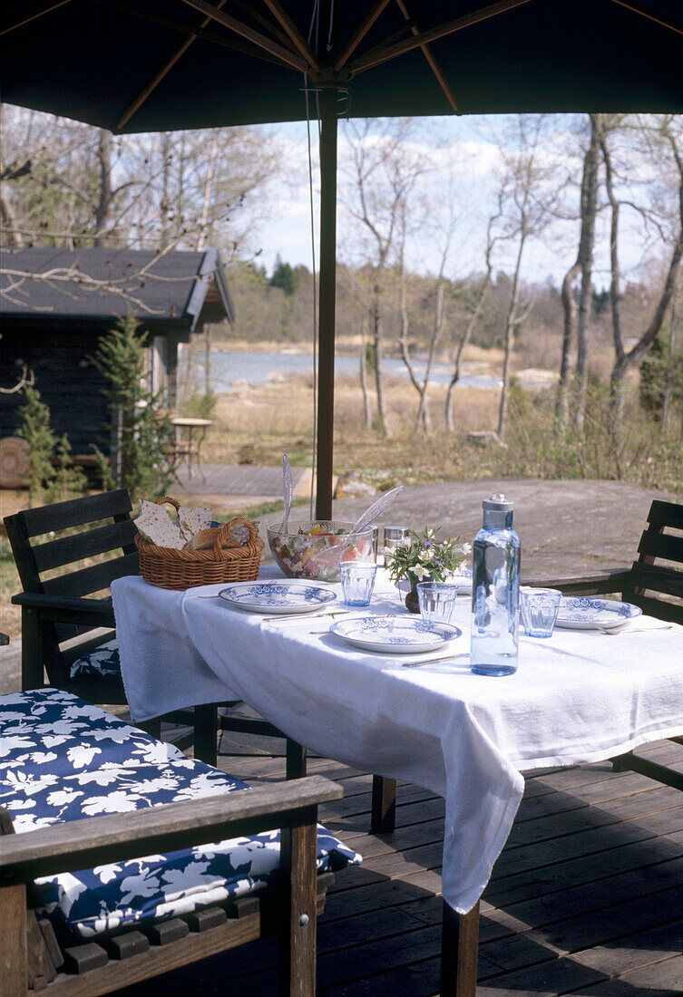 Detail of wooden furniture set outside a wooden summerhouse