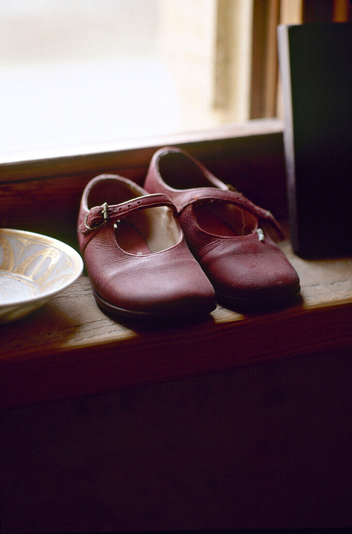 Childs shoes on window sill