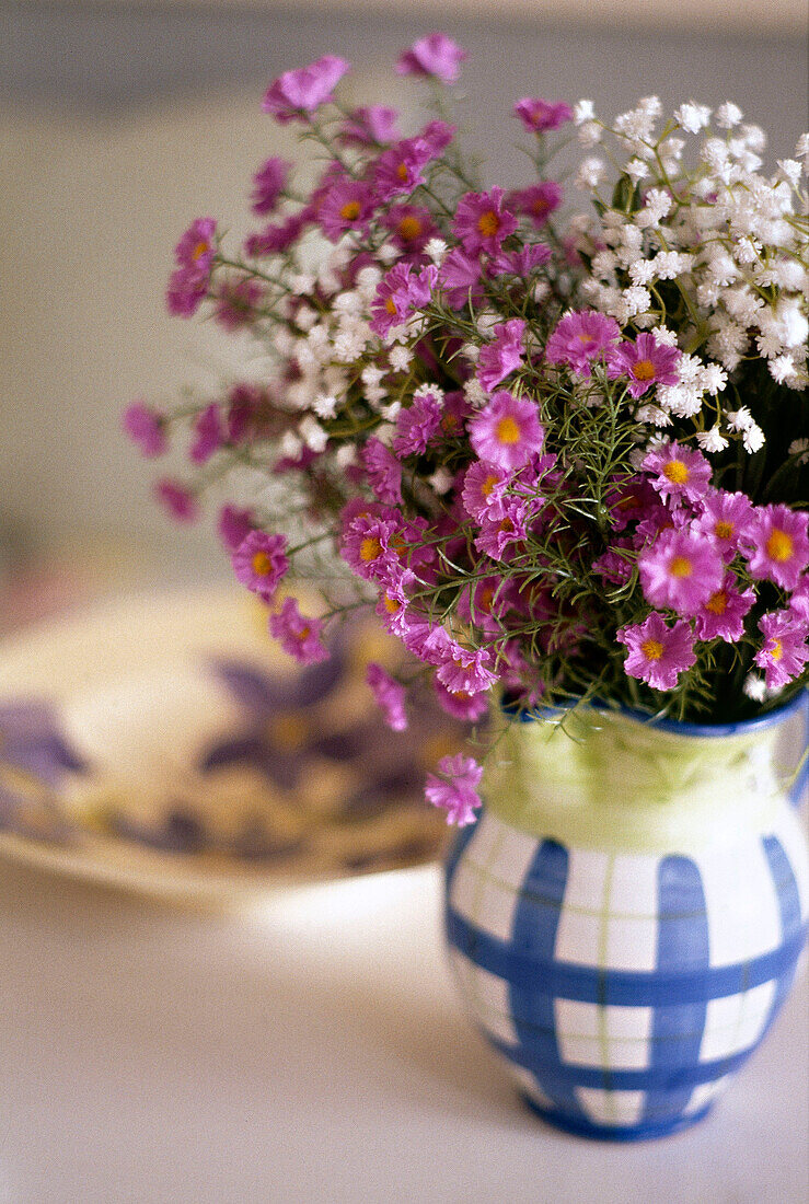 Pink and white flowers in ceramic jug