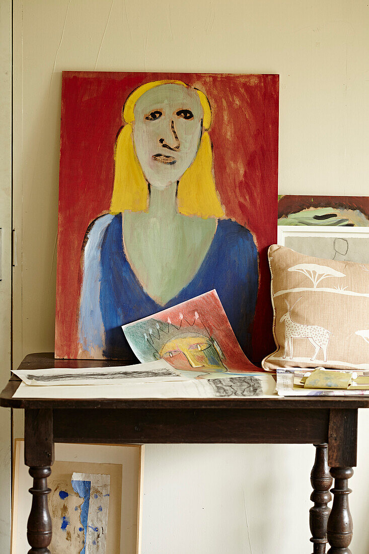 Art canvas and cushion on table in Cotswold studio of textile designer, UK