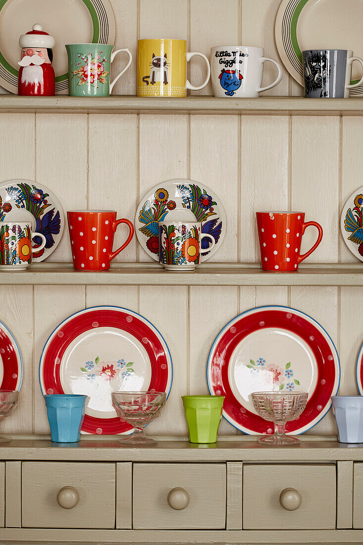 Variety of cups and plates on painted dresser in Bridport kitchen Dorset, UK